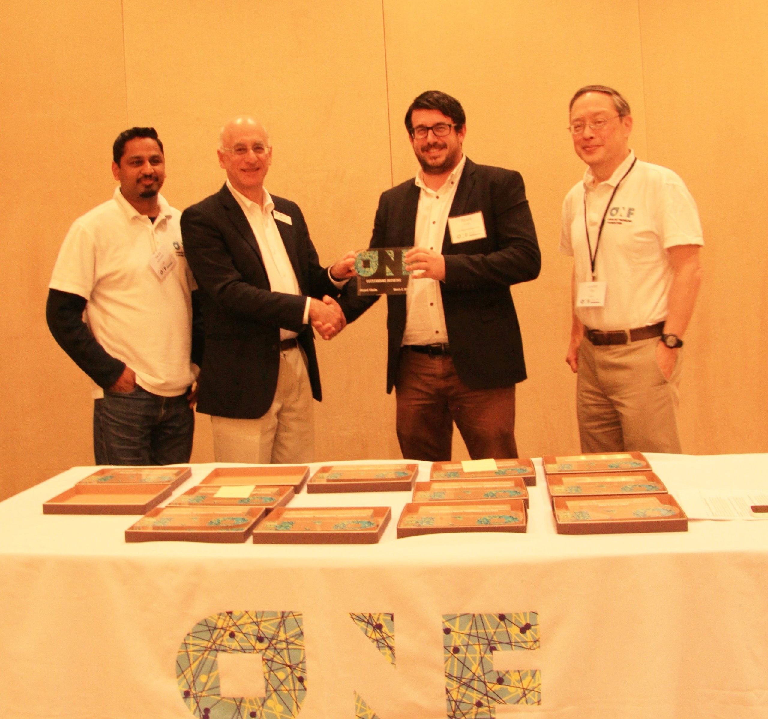 Front left to right: Karthik Sethuraman (NEC), Dan Pitt (ONF Executive Director), Ricard Vilalta (CTTC), Lyndon Ong (Ciena)